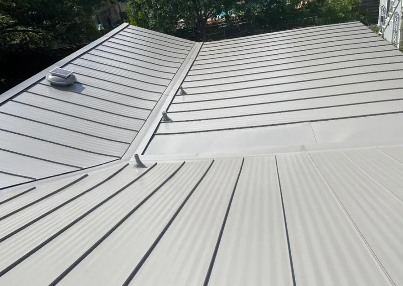 Solar attic fan installed on a metal roof for Roof Ventilation in Gardere